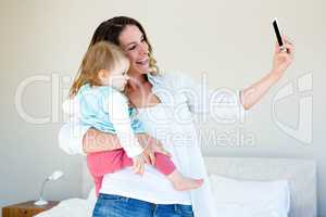 smiling woman taking a selfie with a baby