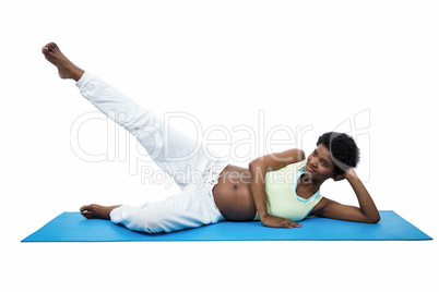 Pregnant woman doing exercise on mat