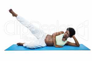 Pregnant woman doing exercise on mat