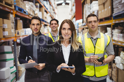 Portrait of warehouse manager and workers