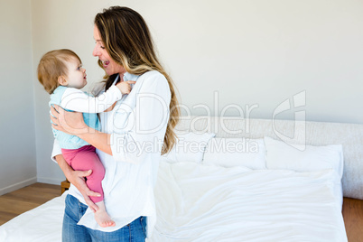 smiling woman holding an adorable baby