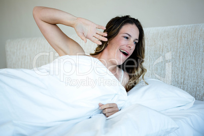 tired woman waking up and yawning