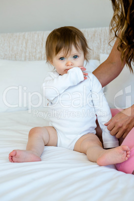 adorable baby chewing on her sleeve