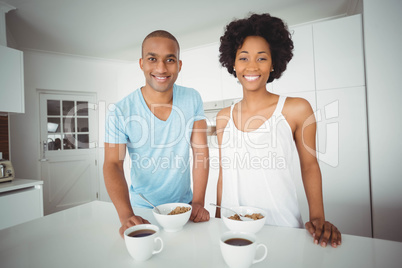 Portrait of smiling couple standing in the kitchen