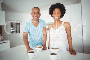 Portrait of smiling couple standing in the kitchen