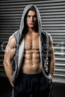 Portrait of shirtless man with grey jumper