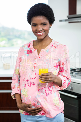 Pregnant woman drinking orange juice