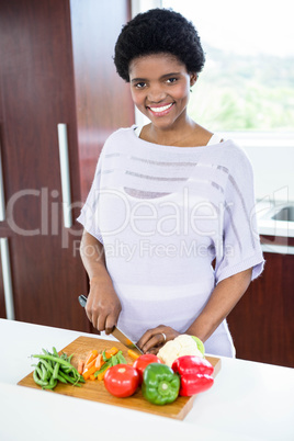 Pregnant woman preparing vegetables