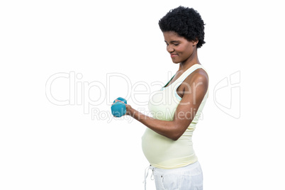 Pregnant woman lifting dumbbell