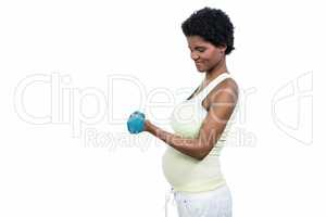 Pregnant woman lifting dumbbell