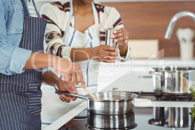 Midsection of couple cooking together