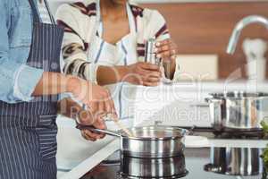 Midsection of couple cooking together