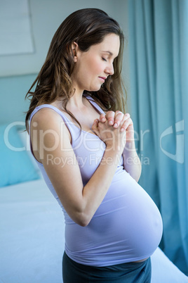 Pregnant woman holding her hands together