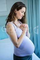 Pregnant woman holding her hands together