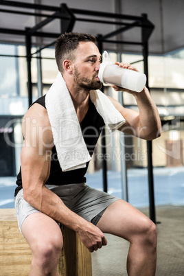 Muscular man drinking protein shake