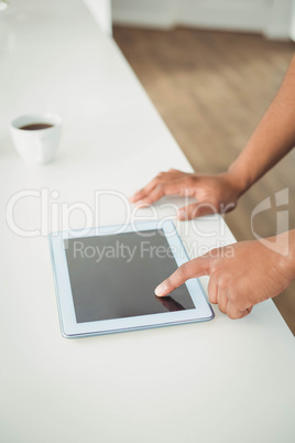 Mans hands using tablet