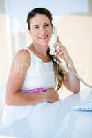 smiling pregnant businesswoman on the phone