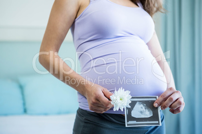 Pregnant woman holding an ultrasound