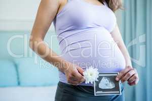 Pregnant woman holding an ultrasound