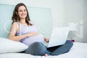 Pregnant woman using her laptop