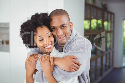 Happy couple hugging in the kitchen