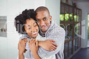 Happy couple hugging in the kitchen