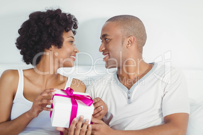 Handsome man giving present to his girlfriend