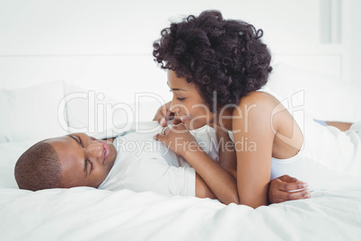 Happy couple lying on the bed