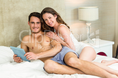 Portrait of young couple relaxing on bed