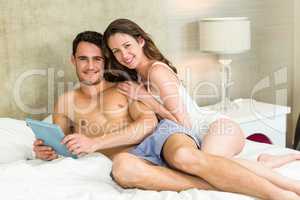 Portrait of young couple relaxing on bed