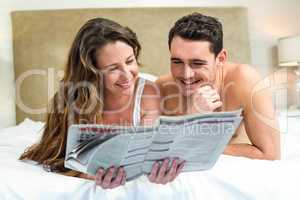 Smiling couple lying in bed