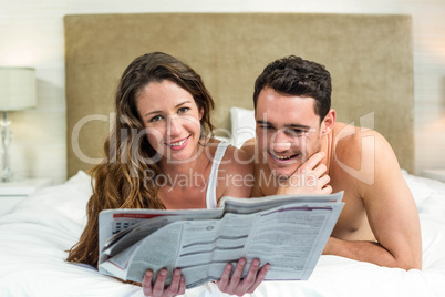 Smiling couple lying in bed