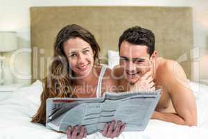 Smiling couple lying in bed