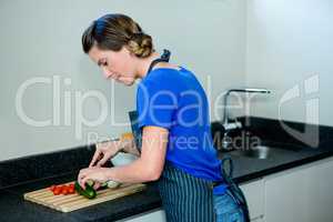 Happy woman preparing some vegetables