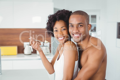 Happy couple eating fruit together