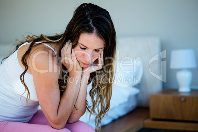 sad woman sitting on her bedroom