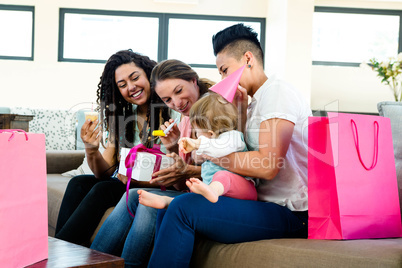 Three women celebrating a babies first birthday