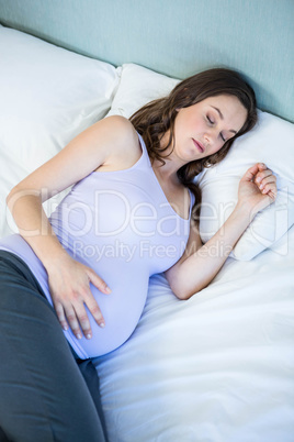 Pregnant woman sleeping in bedroom