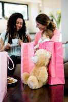 Two women with a baby surrounded by presents