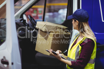 Delivery driver checking his list on clipboard