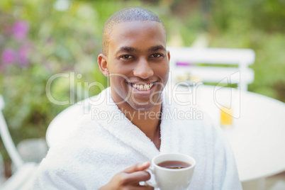 Handsome man holding cup