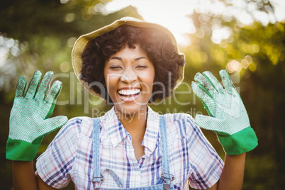 happy woman showing her gardening gloves