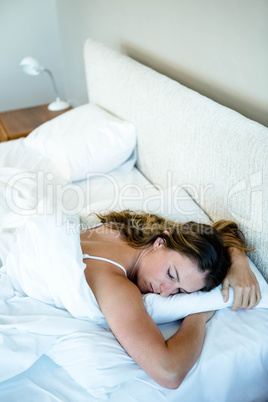 peaceful woman asleep in her bed