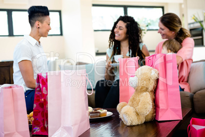 3 women and a baby surrounded by gifts