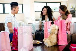3 women and a baby surrounded by gifts