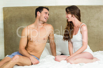 Young couple having fun on bed