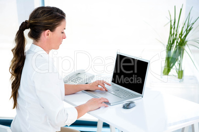 business woman tying on her laptop