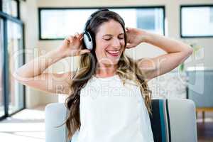smiling woman listening to music on her headphones