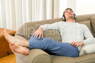 Young man feeling relaxed while listening to music