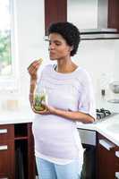 Pregnant woman eating pickles